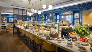 A breakfast buffet with a variety of food items and a modern interior design.