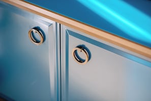 A close-up of a blue cabinet with two metallic handles. - Hilton Imperial Dubrovnik (Dubrovnik)