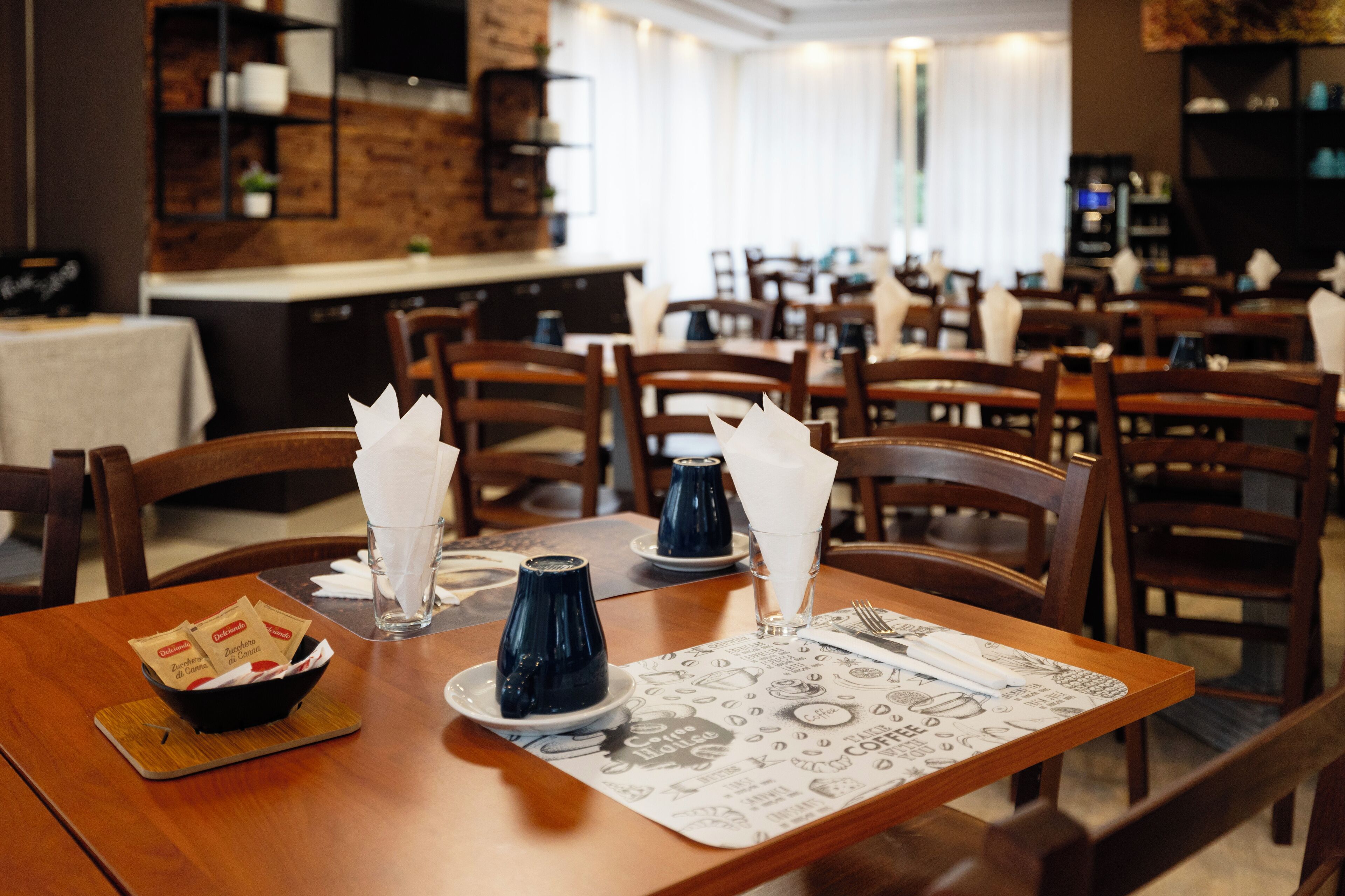 A restaurant with wooden tables, chairs, and a menu mat.