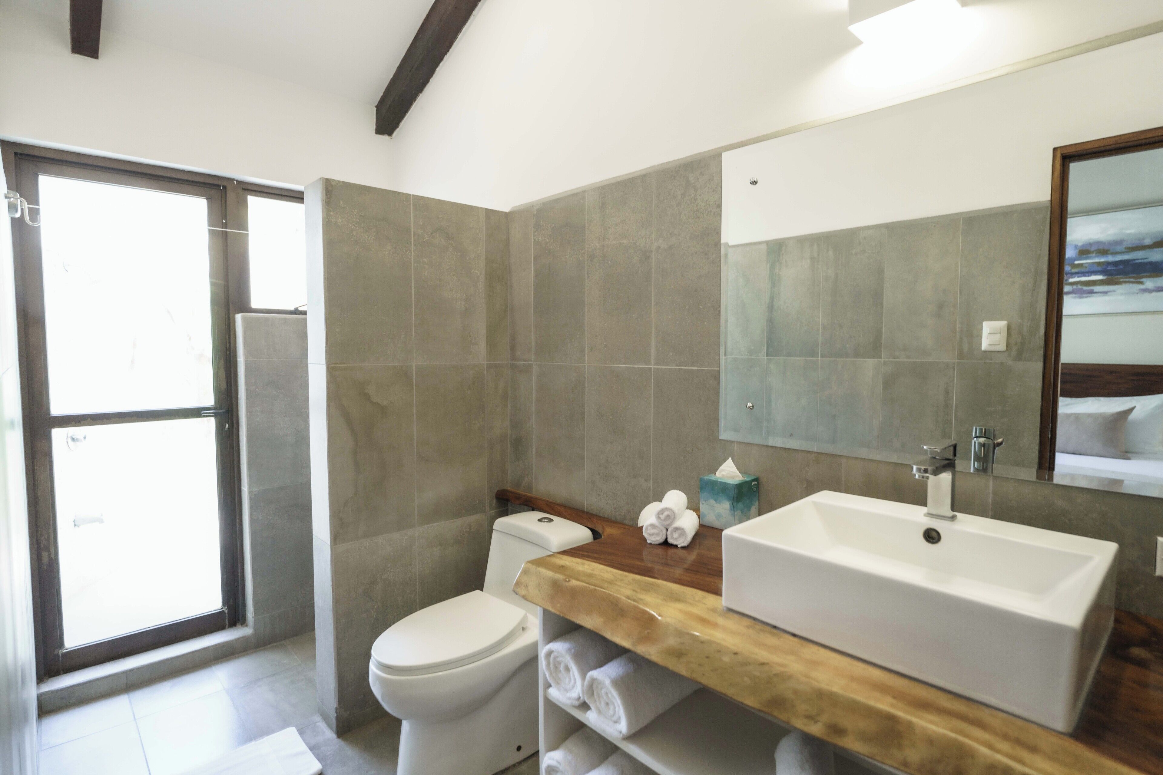 A modern bathroom with a large bathtub, a toilet, and a sink.