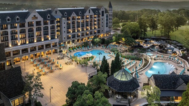 A hotel with multiple swimming pools, outdoor seating areas, and a large building with multiple floors and balconies. - Renaissance Birmingham Ross Bridge Golf Resort & Spa (Birmingham)