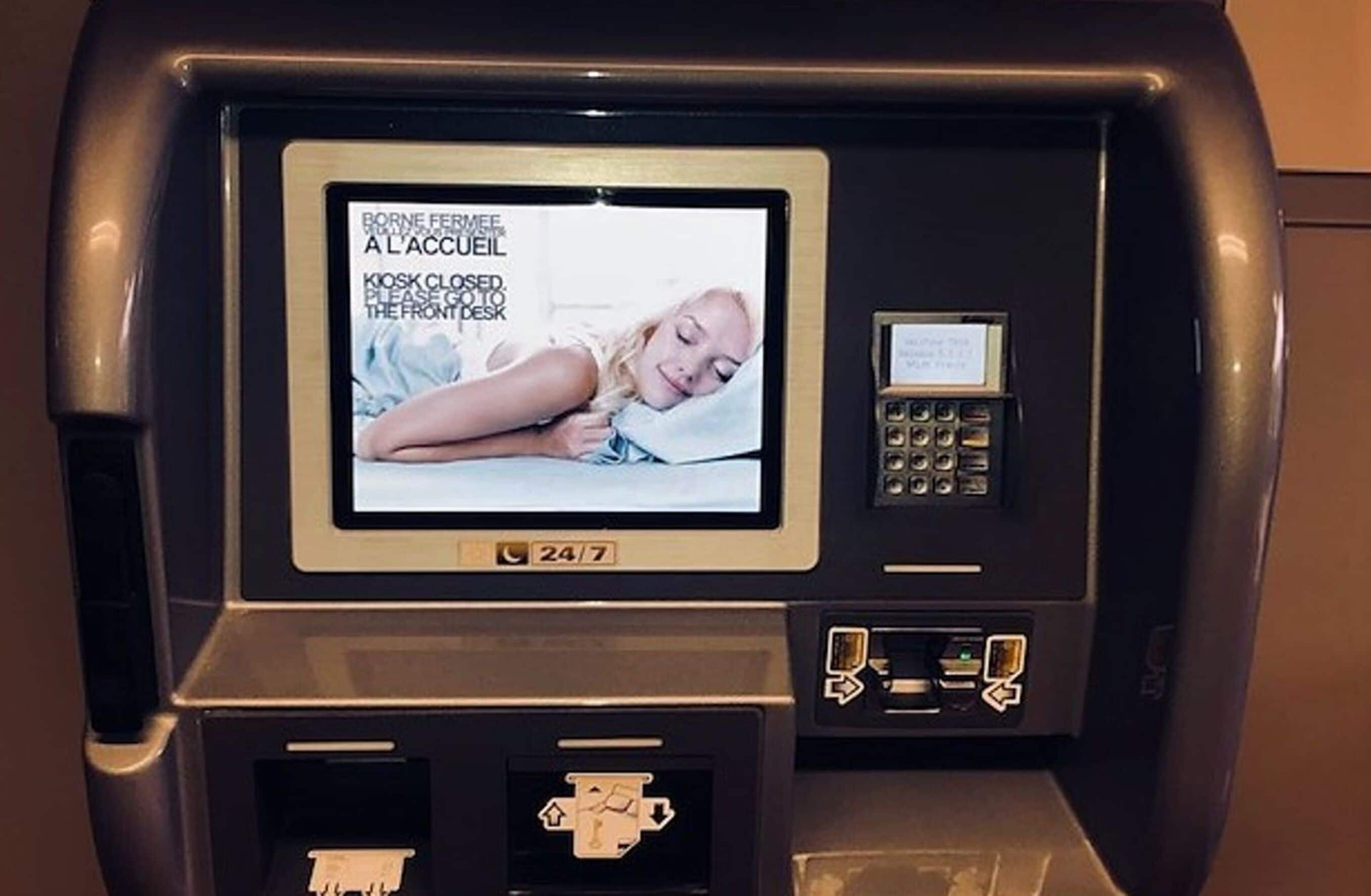 A self-service kiosk with a screen displaying a message about a closed kiosk and a 24/7 service.