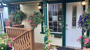 A wooden deck with potted plants and a door labeled "Entrance". - Ellis House B&B, Niagara Falls (Niagara Falls)