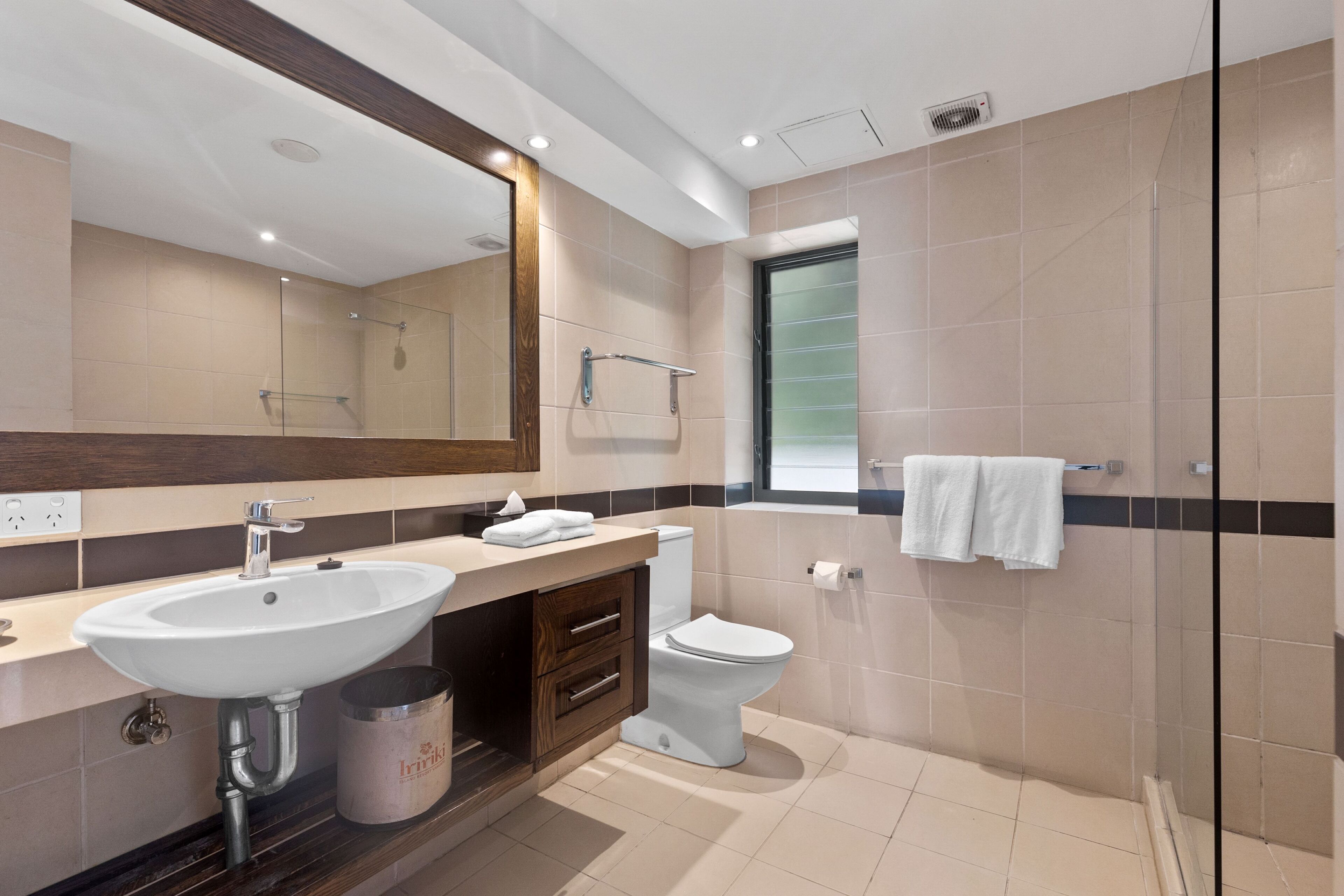 Un baño moderno con un lavamanos grande, inodoro y zona de ducha.