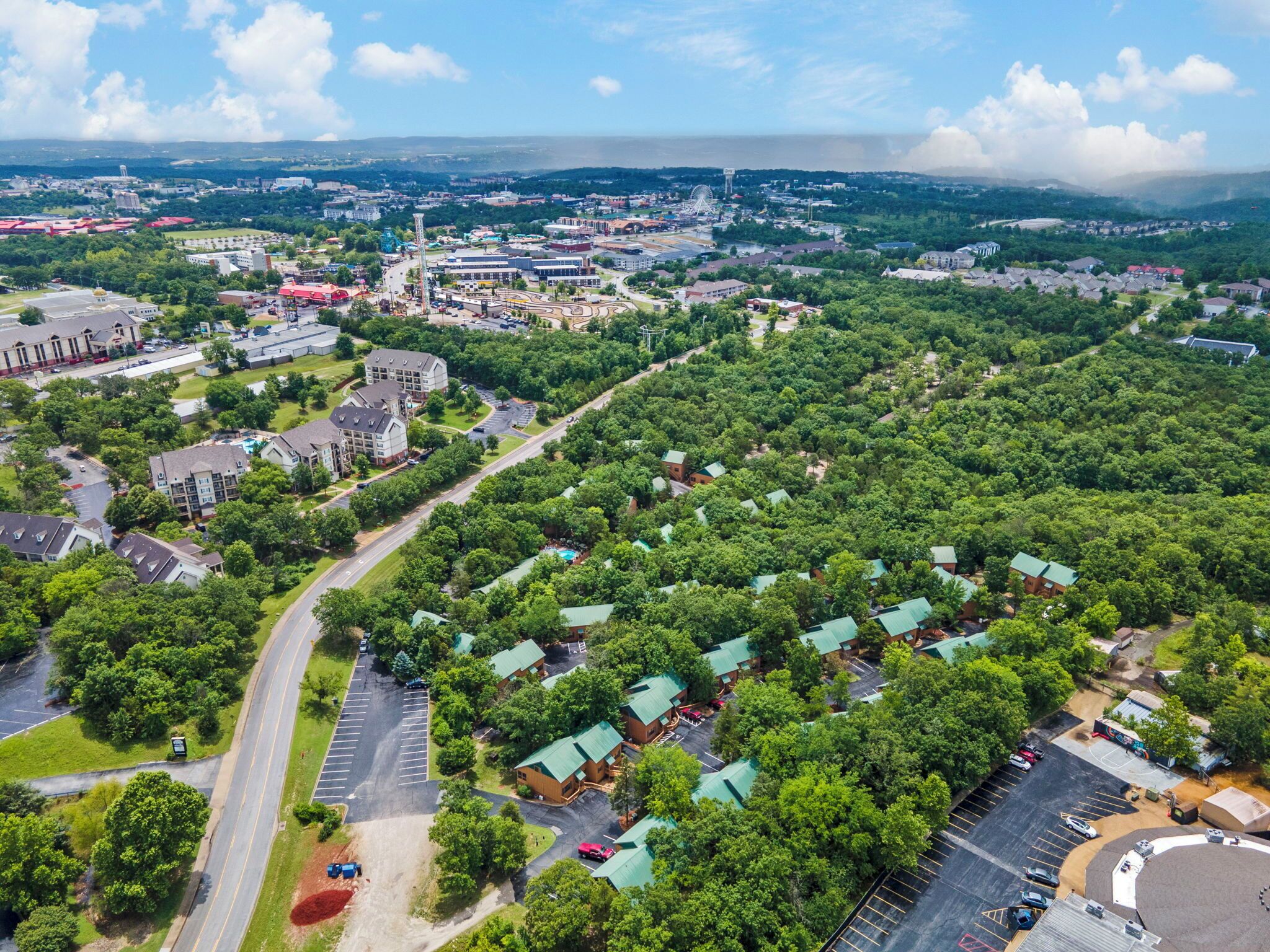 An aerial view of a residential area with houses, roads, and a large building complex.