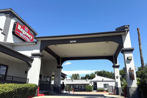 A hotel entrance with a sign for 'Regency Suites'.