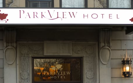 The Parkview Hotel entrance with a prominent sign, decorative stonework, and a flower display in the foreground.