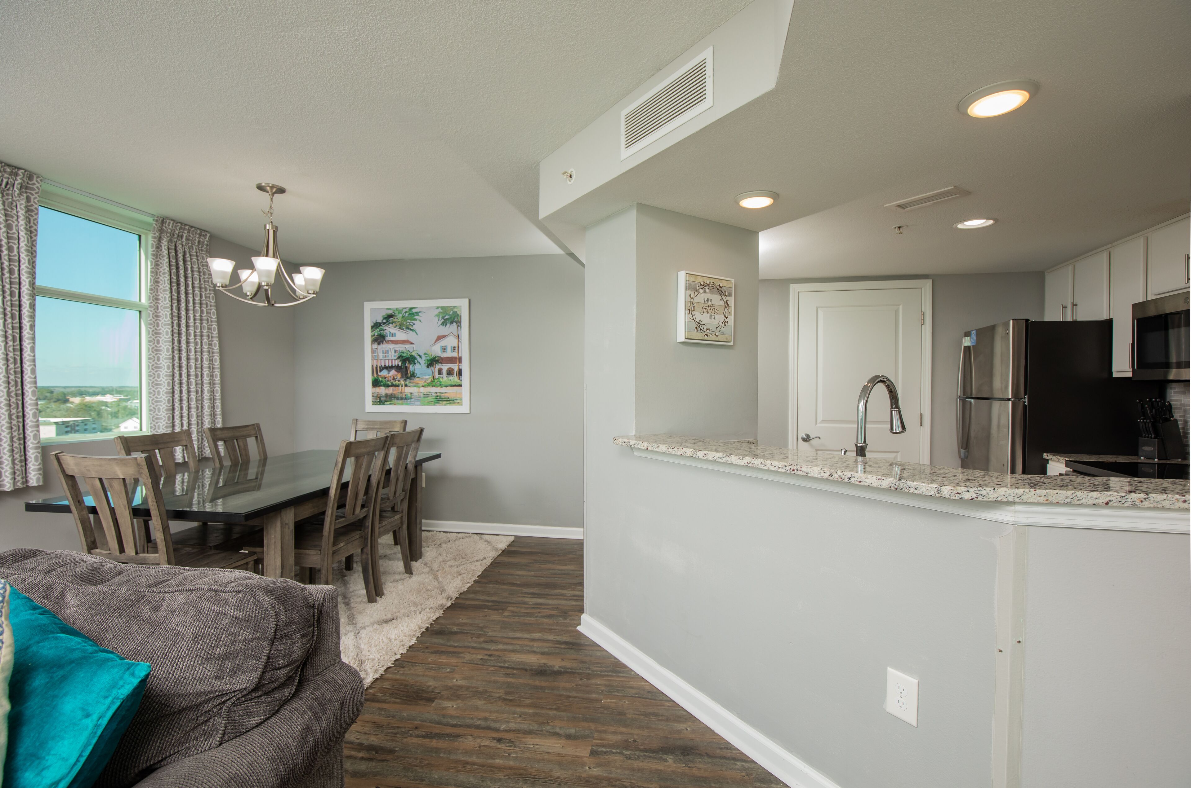 A modern kitchen with a built-in refrigerator, microwave, and stainless steel appliances.