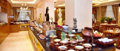 A buffet setup with various food items and utensils.