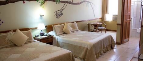 A hotel room with two beds, a nightstand, a lamp, a chair, and a shower area.