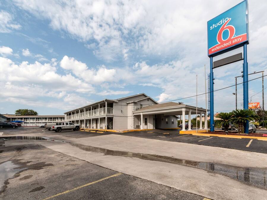 Un motel avec une grande enseigne indiquant « Studio 6, séjour prolongé ».