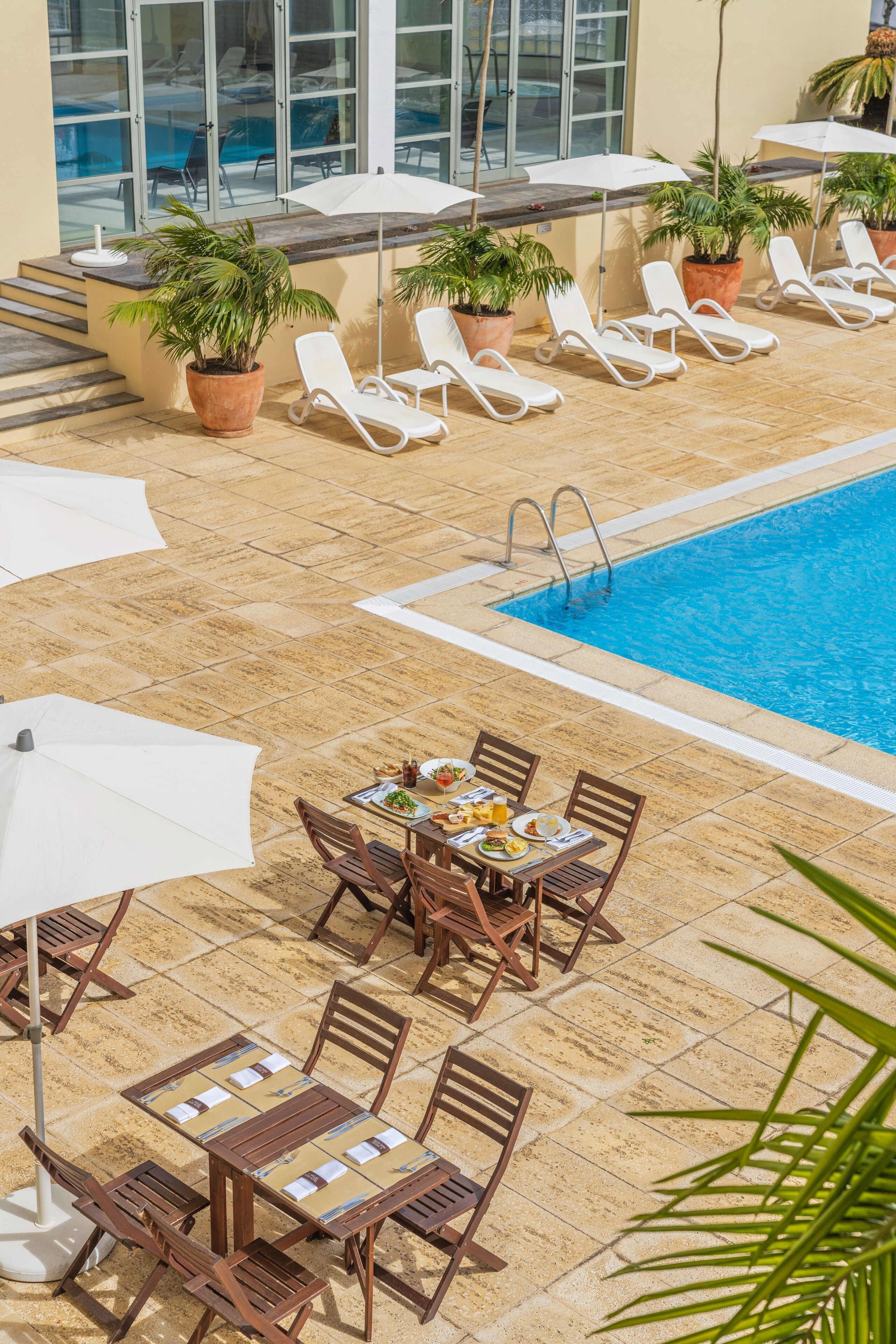 indoor pool, outdoor pool, pool umbrellas, pool loungers