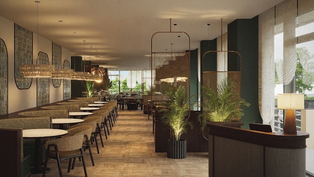 Un restaurante moderno con una barra larga, varias mesas y lámparas colgantes.