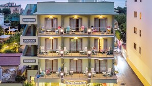 A multi-story hotel with outdoor seating and a garden area. - Gardenia Sorrento Coast, Ascend Hotel Collection (Sorrento)