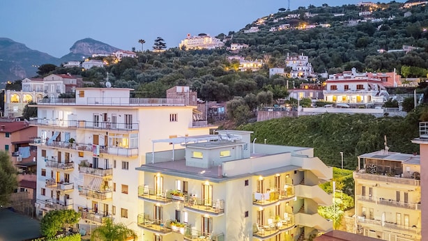A multi-story hotel with balconies, a swimming pool, and a view of a hillside. - Gardenia Sorrento Coast, Ascend Hotel Collection (Sorrento)