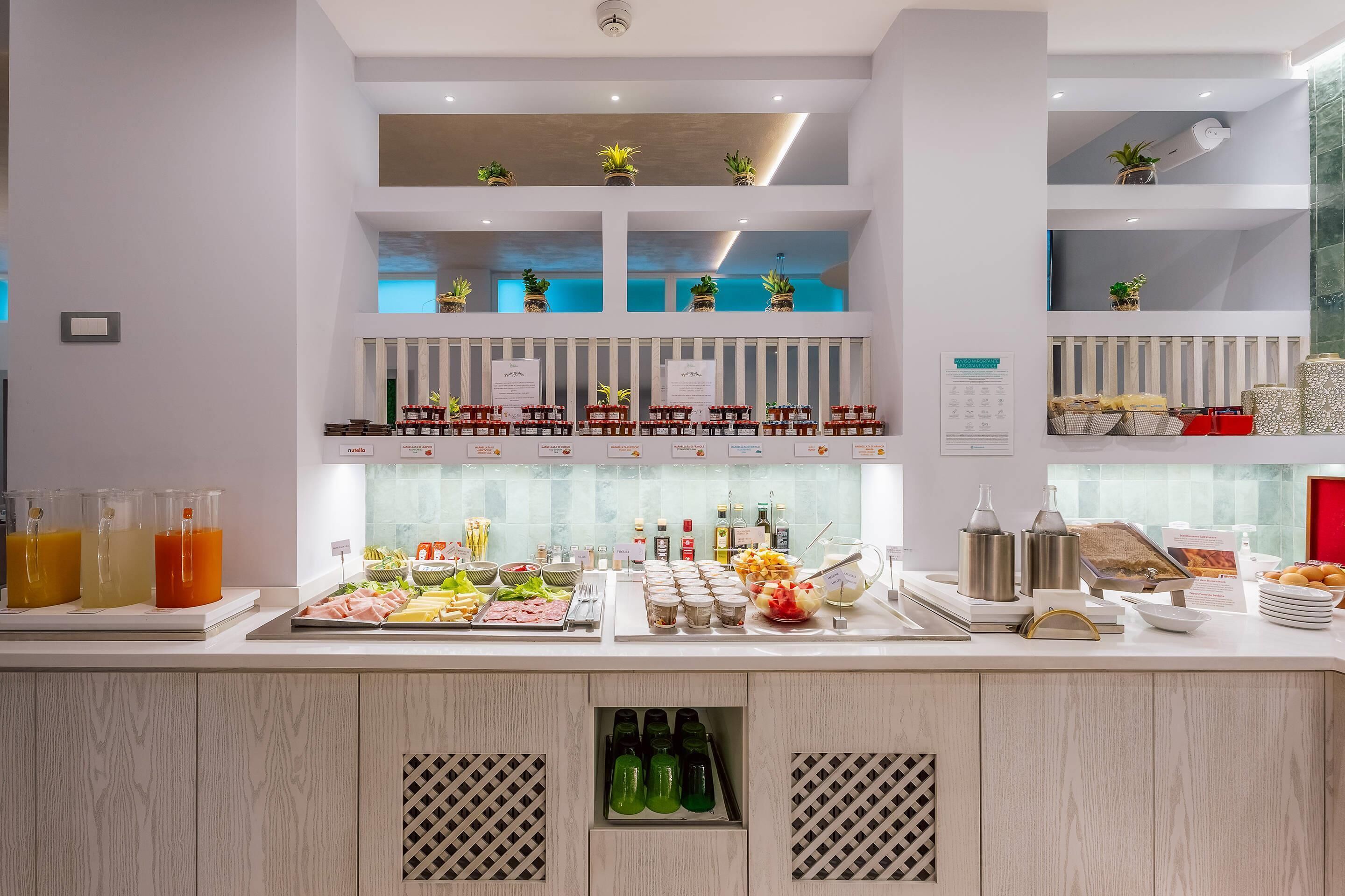 A buffet area with various food items and drinks.