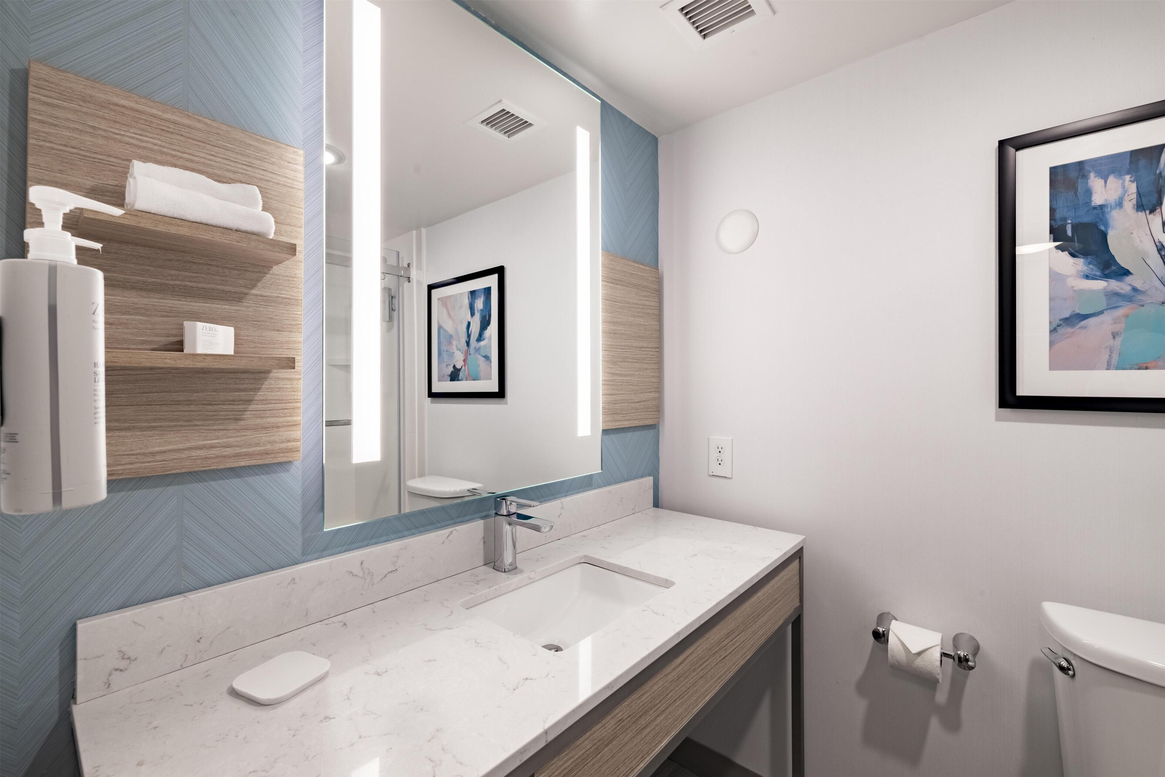 Combined shower/tub, designer toiletries, hair dryer, towels