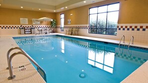 An indoor swimming pool with clear water, safety signs, and a tiled wall. - Hampton Inn & Suites Cincinnati-Union Center (West Chester)