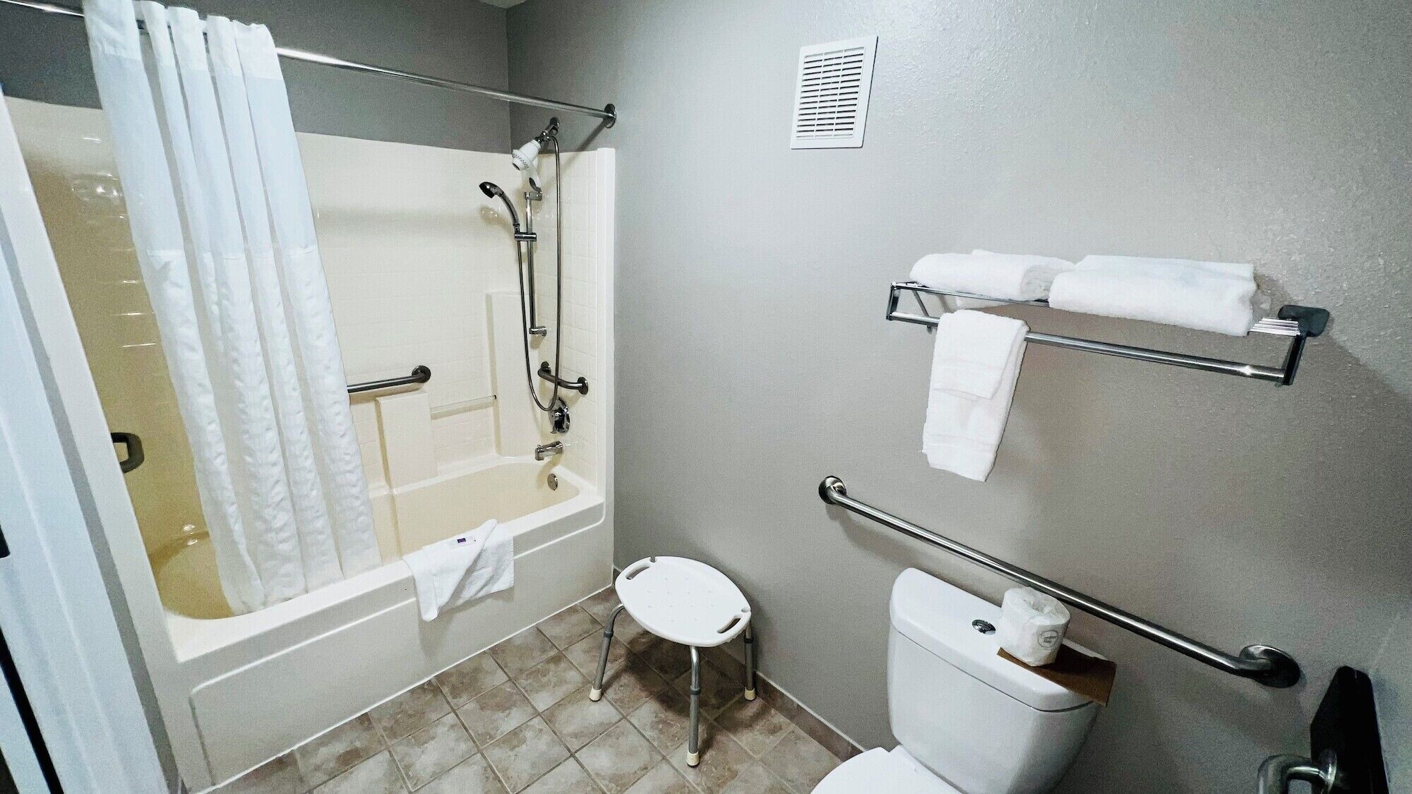A bathroom with a bathtub, toilet, and shower.