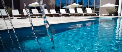 Seasonal outdoor pool, pool loungers