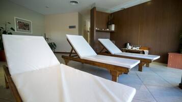 Relax in comfort with two lounge chairs and a potted plant.