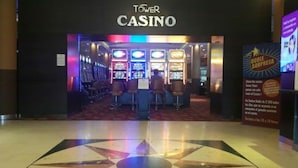 A casino interior with gaming machines and a sign reading "TOWER CASINO".