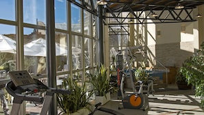 A gym with treadmills, stationary bikes, and exercise equipment.