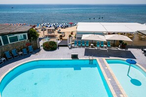 Seasonal outdoor pool, a lap pool, pool umbrellas, pool loungers