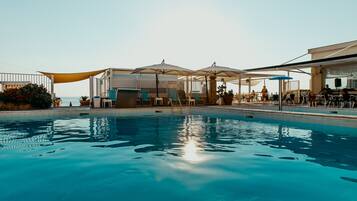 Seasonal outdoor pool, a lap pool, pool umbrellas, pool loungers