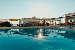 Seasonal outdoor pool, a lap pool, pool umbrellas, sun loungers