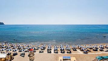 Private beach, white sand, sun loungers, beach umbrellas
