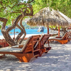 On the beach, white sand, sun-loungers, beach umbrellas
