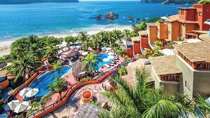 A resort with a pool, beach, and ocean views.