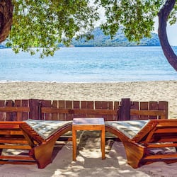 On the beach, white sand, sun loungers, beach umbrellas