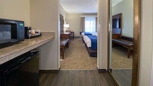 A hotel room with a kitchenette, a bed, a desk, and a TV. - Comfort Inn East Windsor - Springfield (East Windsor)