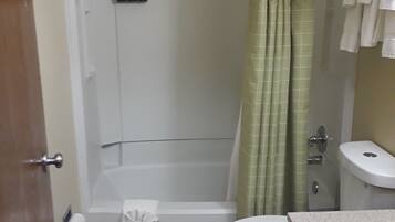 A bathroom with a shower, toilet, and sink.