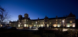 A large, historic building with multiple towers and a well-lit parking area. - Clayton Hotel & Leisure Club Sligo (Sligo)