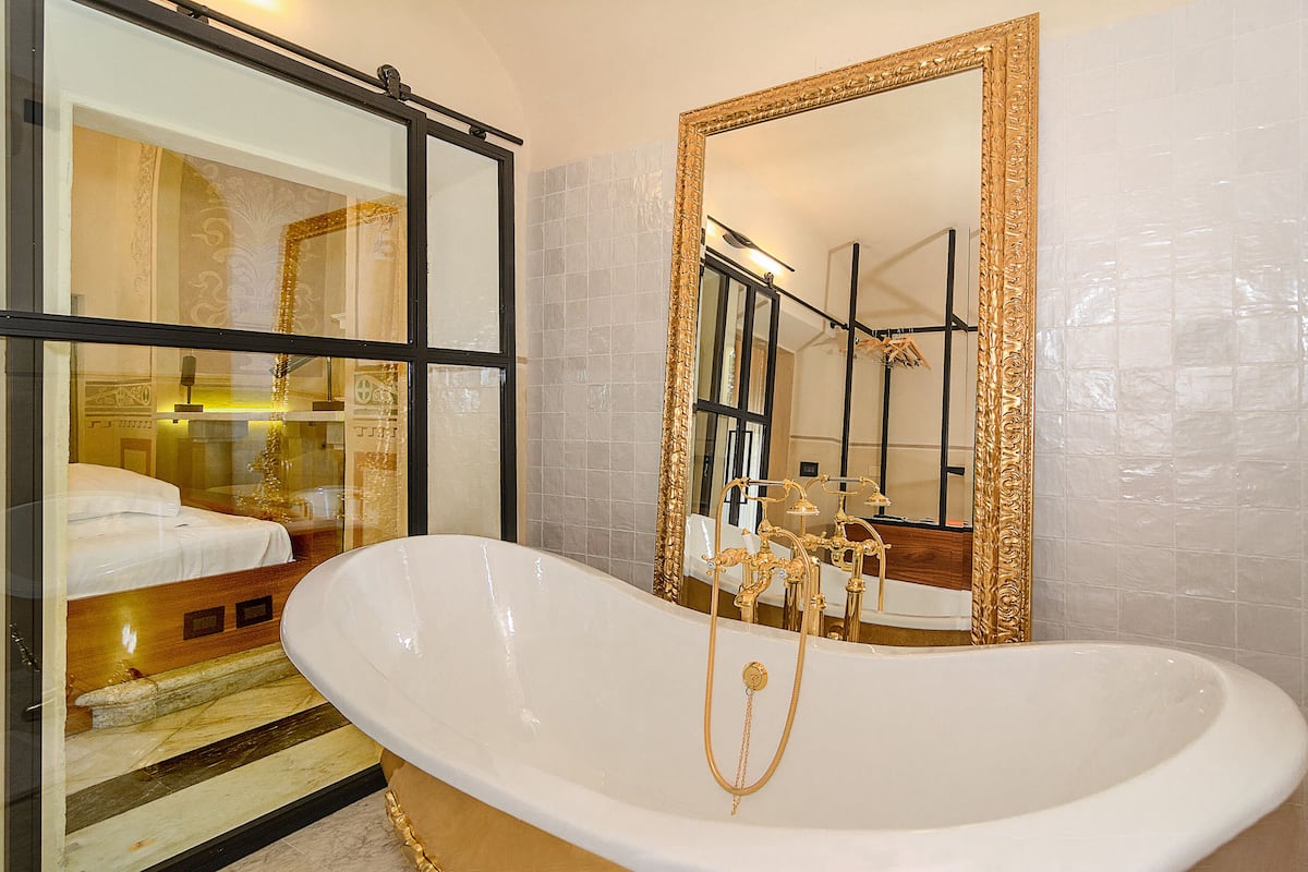 deluxe suite, 1 king bed | bathroom | shower, rainfall showerhead, free toiletries, hair dryer
