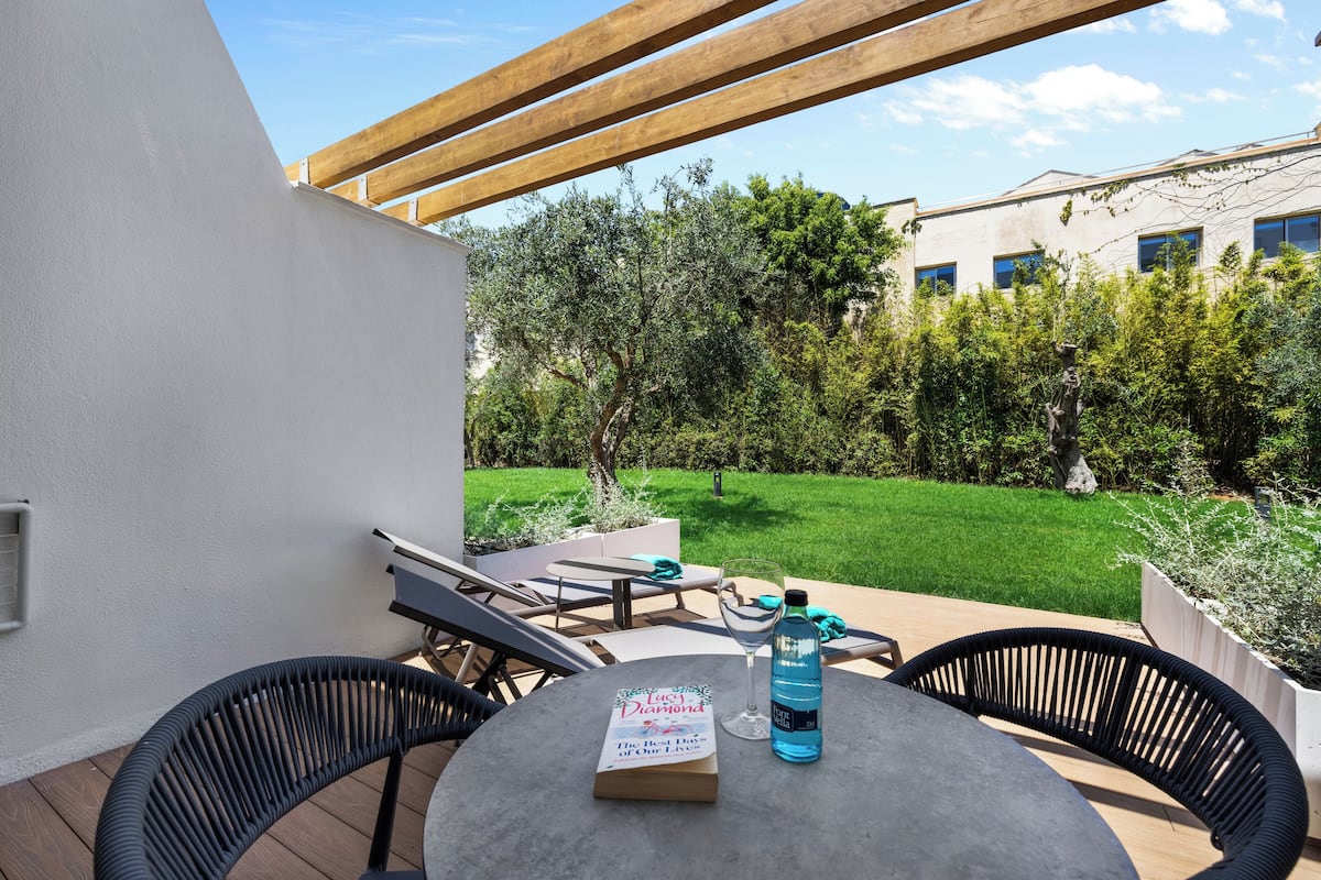 An outdoor patio with a table, chairs, and a book titled "The Best Days of Our Lives".