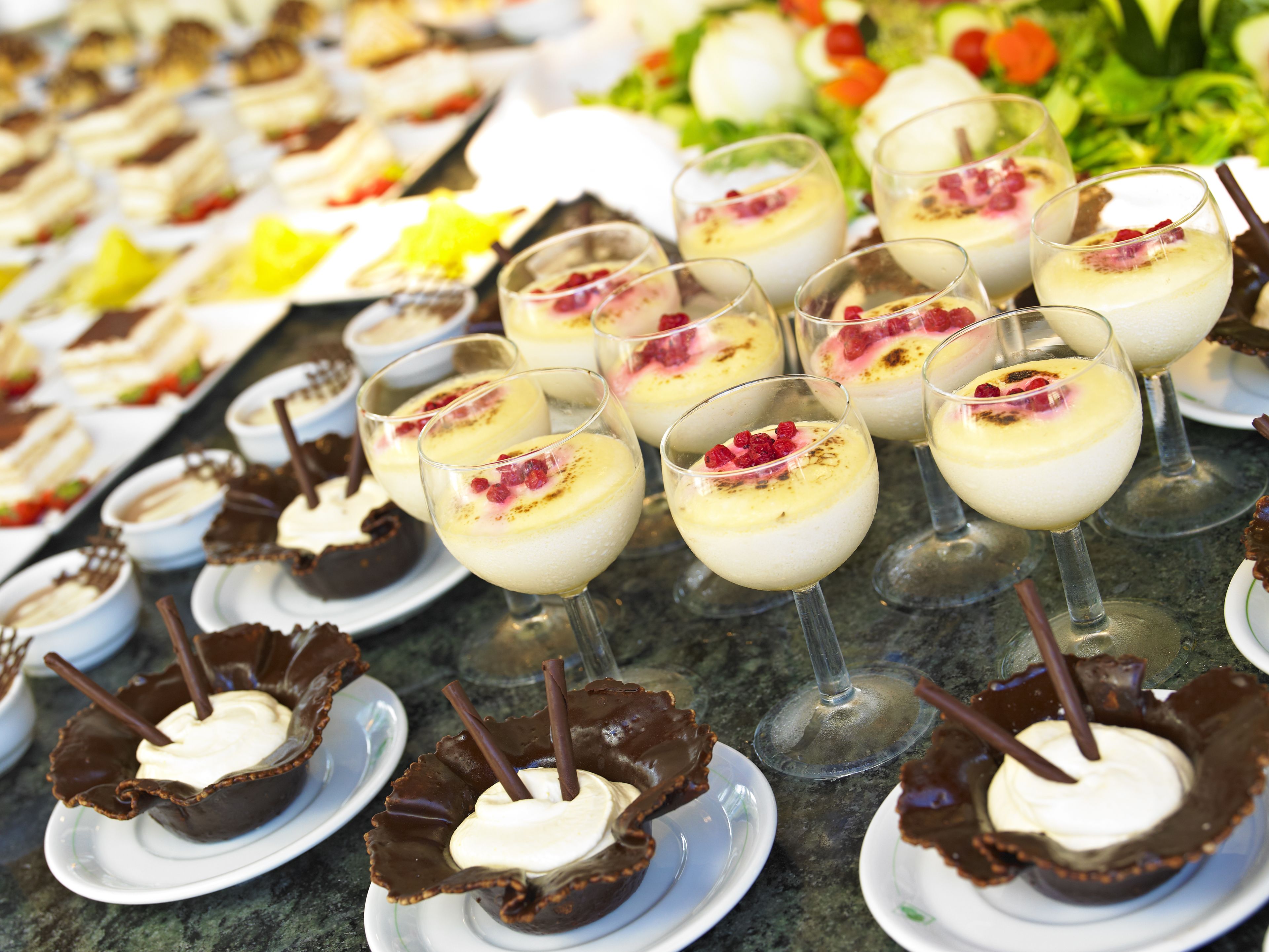 Ein reichhaltiges Buffet mit verschiedenen Desserts, darunter Schokoladensüßigkeiten und cremige Speisen.