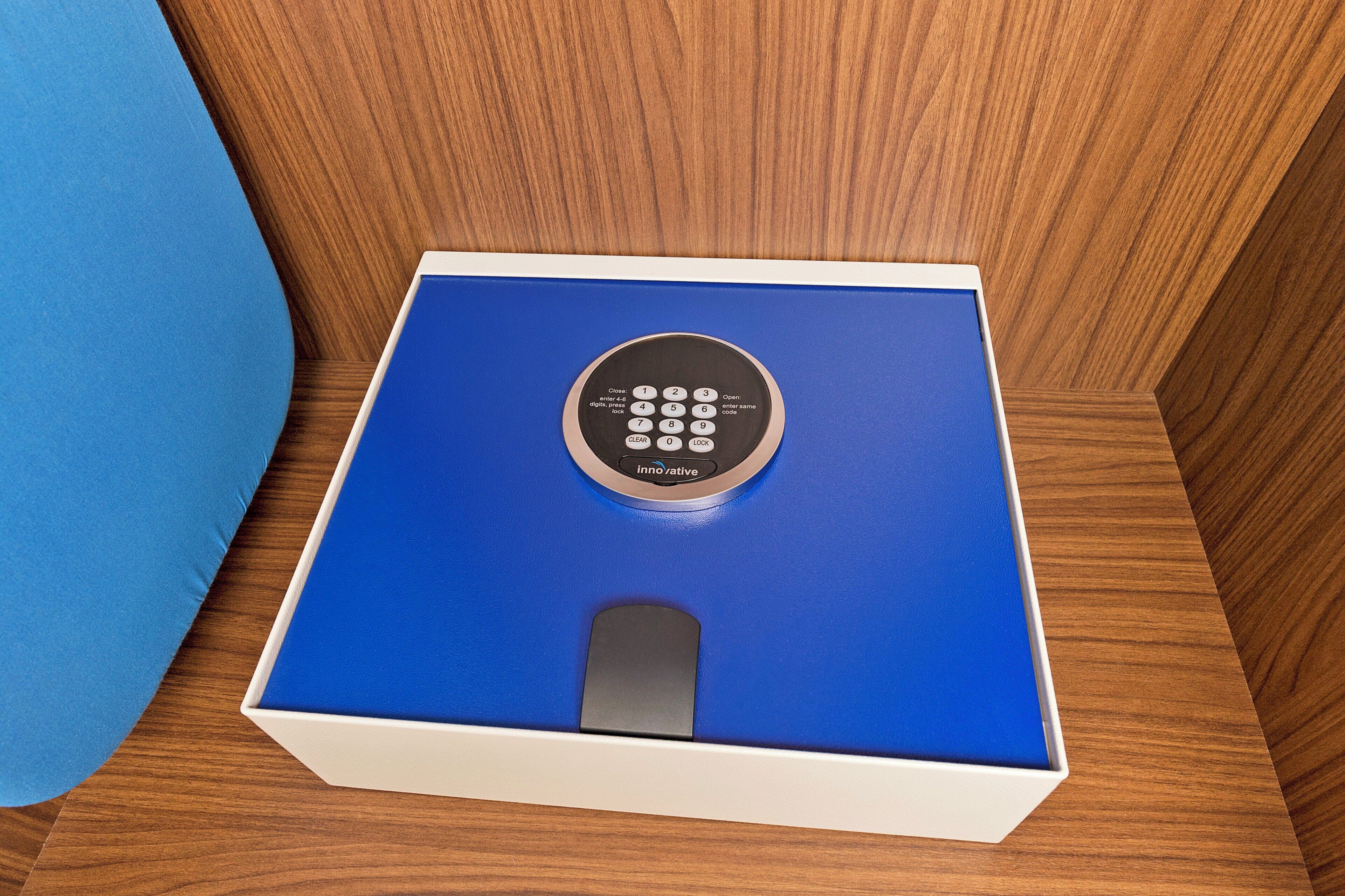 Een blauwe doos met een afstandsbediening erop, op een houten ondergrond.