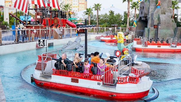 A boat ride with passengers holding binoculars, surrounded by water and themed structures. - Holiday Inn Express Hotel & Suites Chester by IHG (Chester)