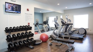 A fitness center with treadmills, elliptical machines, a red exercise ball, and a rack of dumbbells. - Holiday Inn Express Hotel & Suites Chester by IHG (Chester)