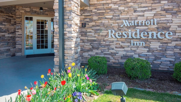A Marriott Residence Inn exterior with stone facade, entrance door, and flower beds. - Residence Inn by Marriott Boise West (Boise)