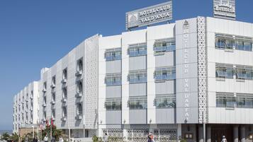 A modern hotel with a prominent sign reading "HOTEL CLUB VAL D'ANFA".