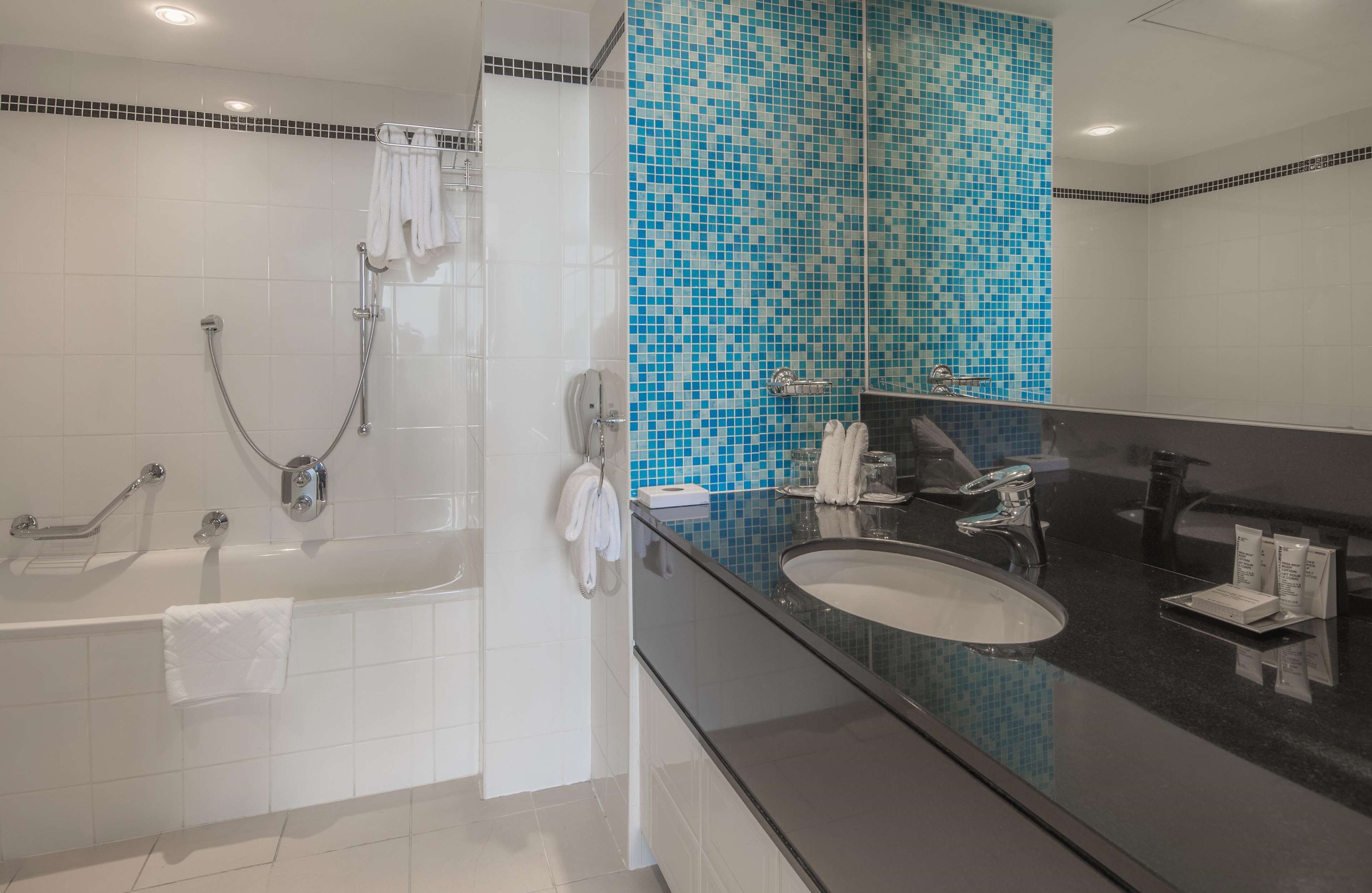suite, 1 king bed, non smoking | bathroom | combined shower/bathtub, deep-soaking bathtub, free toiletries