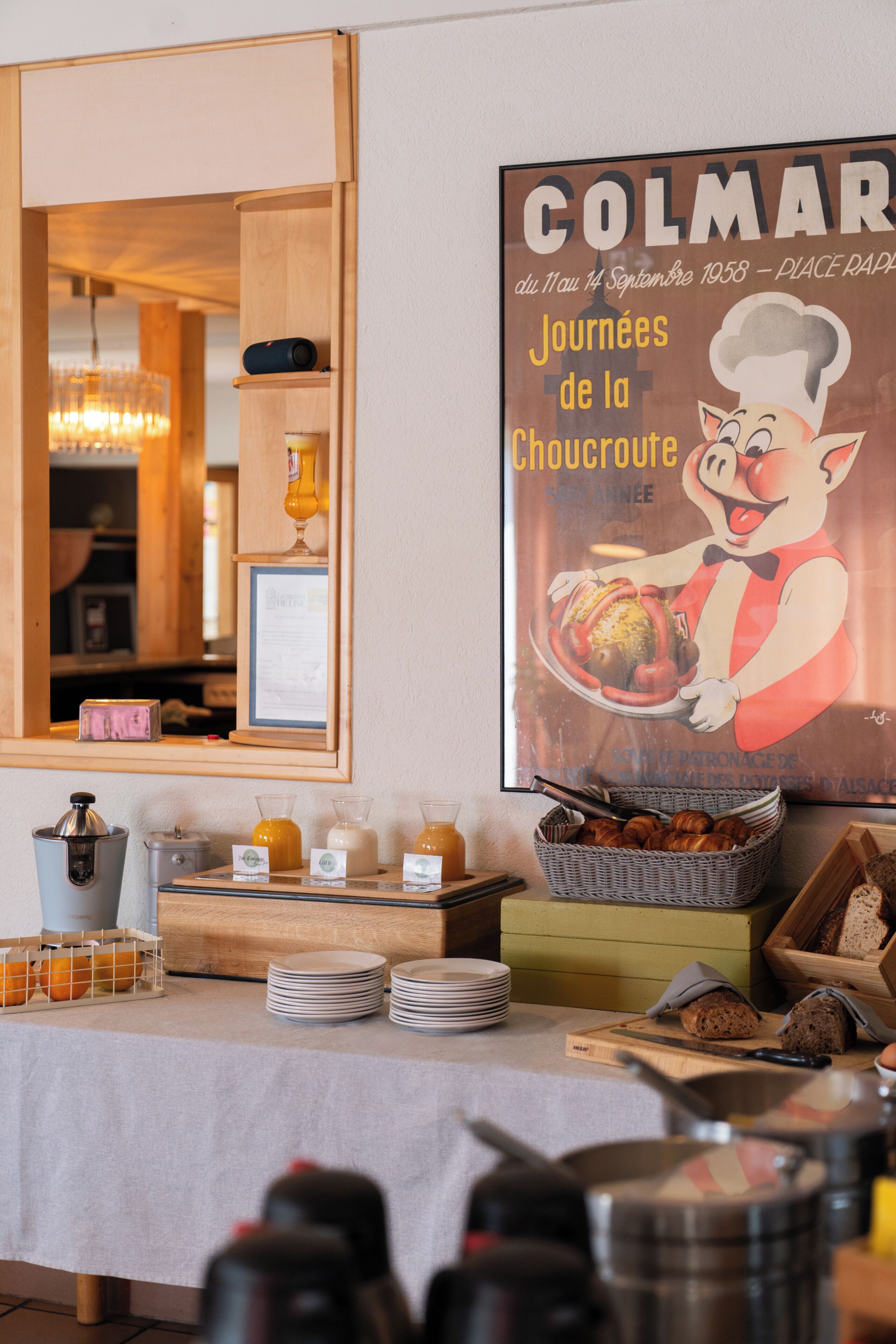 A breakfast buffet setup with various food items and a poster on the wall.