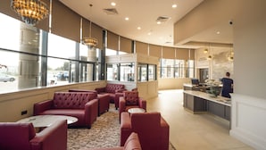 A hotel lobby with seating areas, a reception desk, and large windows. - Da Vinci's Hotel Derry (Londonderry)
