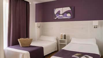 A hotel room with two beds, a nightstand, a wall-mounted painting, and a window with curtains.