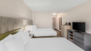 A hotel room with two beds, a TV, a desk with a lamp, and a dresser. - Country Inn & Suites by Radisson, Elk Grove Village/Itasca (Elk Grove Village)